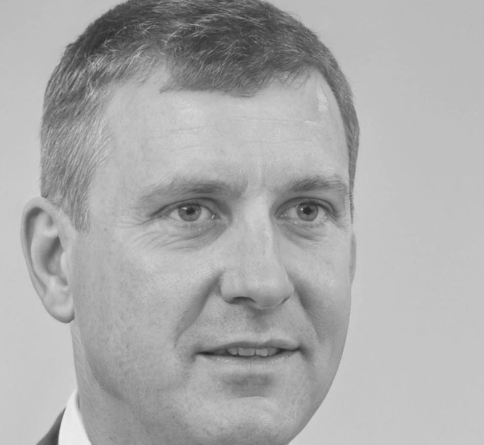 Professional headshot of financial education expert Rowan McAllister